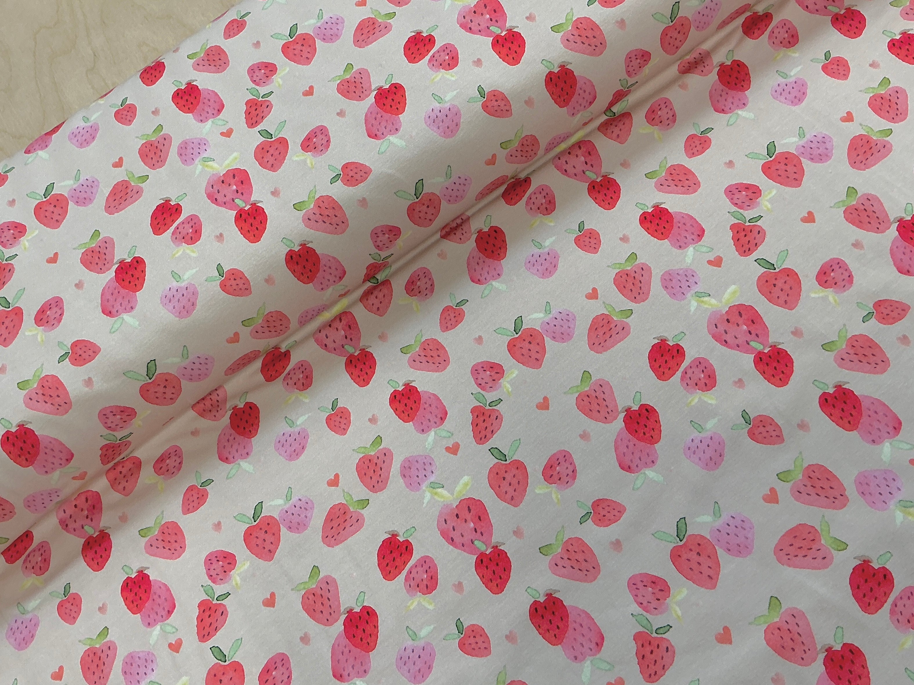 Watercolour Strawberries on Blush Cotton Jersey Fabric