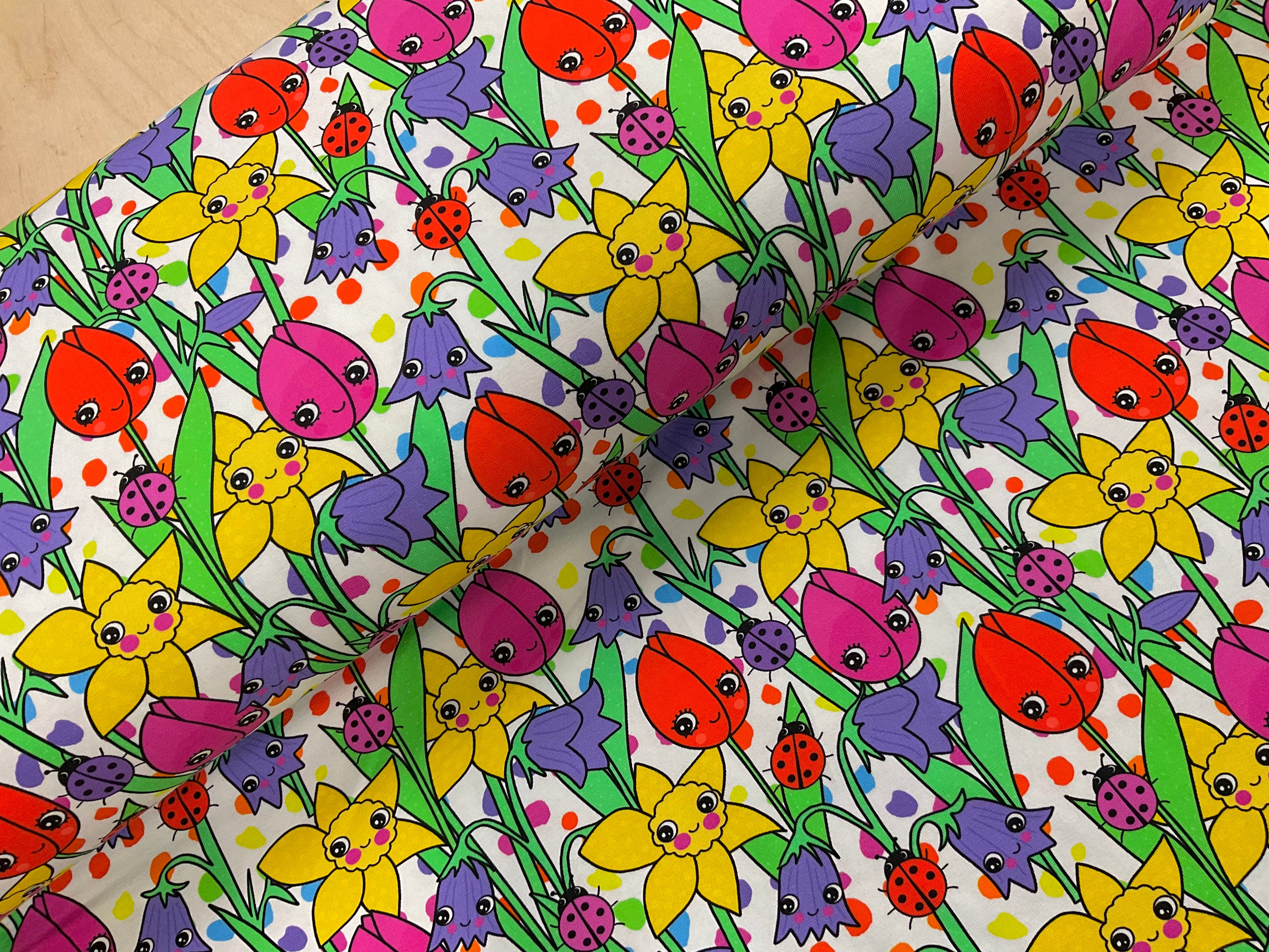 Colourful Flower Faces Cotton Jersey Fabric